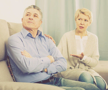 upset mature couple quarreling at home with each other